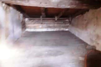 Combles perdus vus en enfilade avant travaux d'isolation
